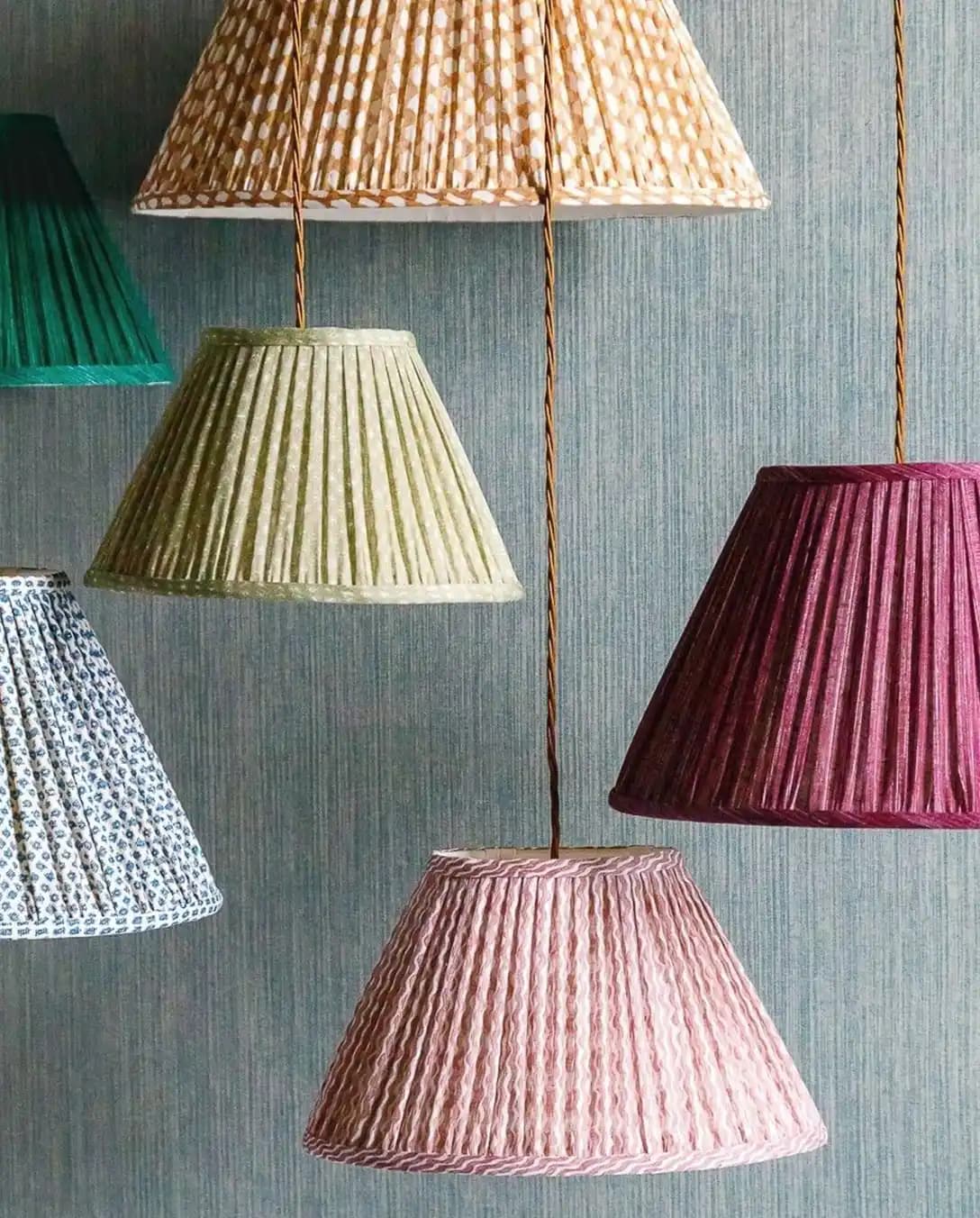 Multi-coloured Fermoie lampshades hang from the top