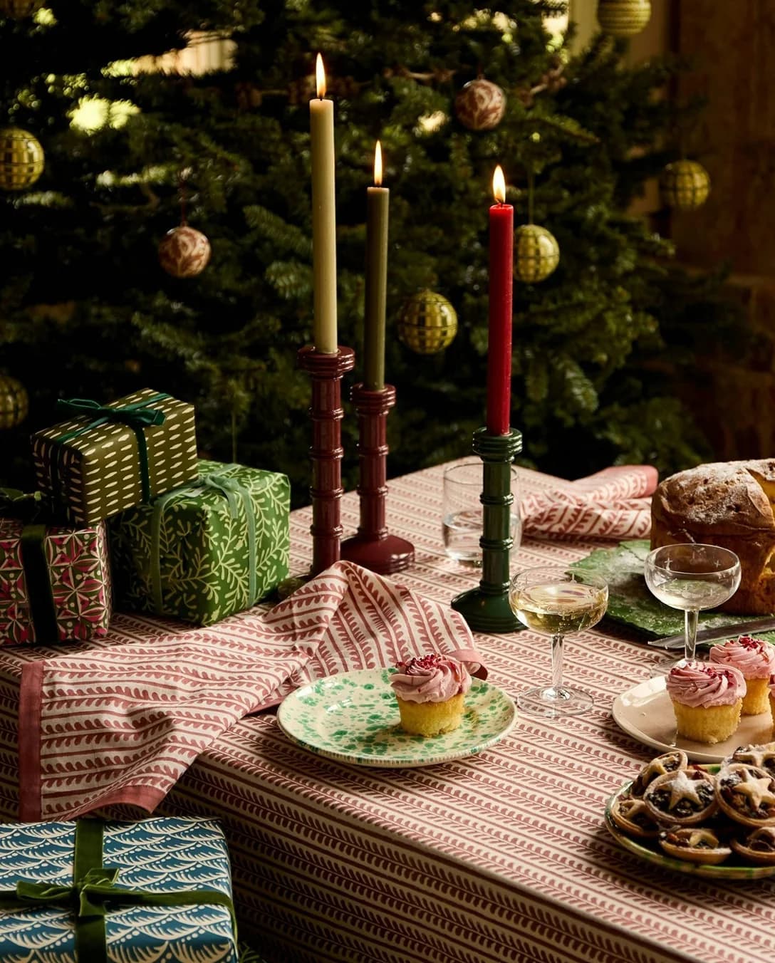 A festive table setting with coupe glassware and painted pottery