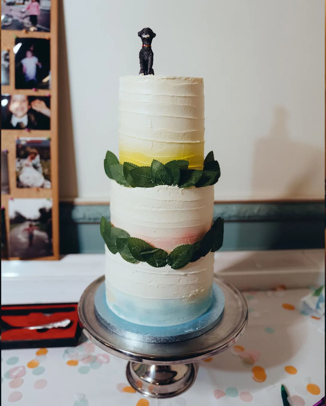 A three tier ombre wedding cake with dog poodle as a topper