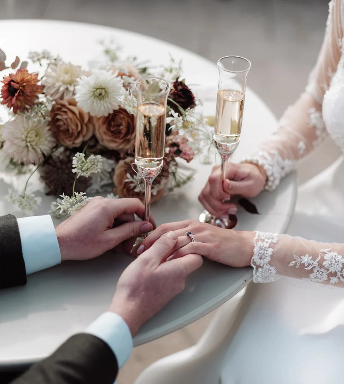 Bride and groom celebrate their wedding with Champagne