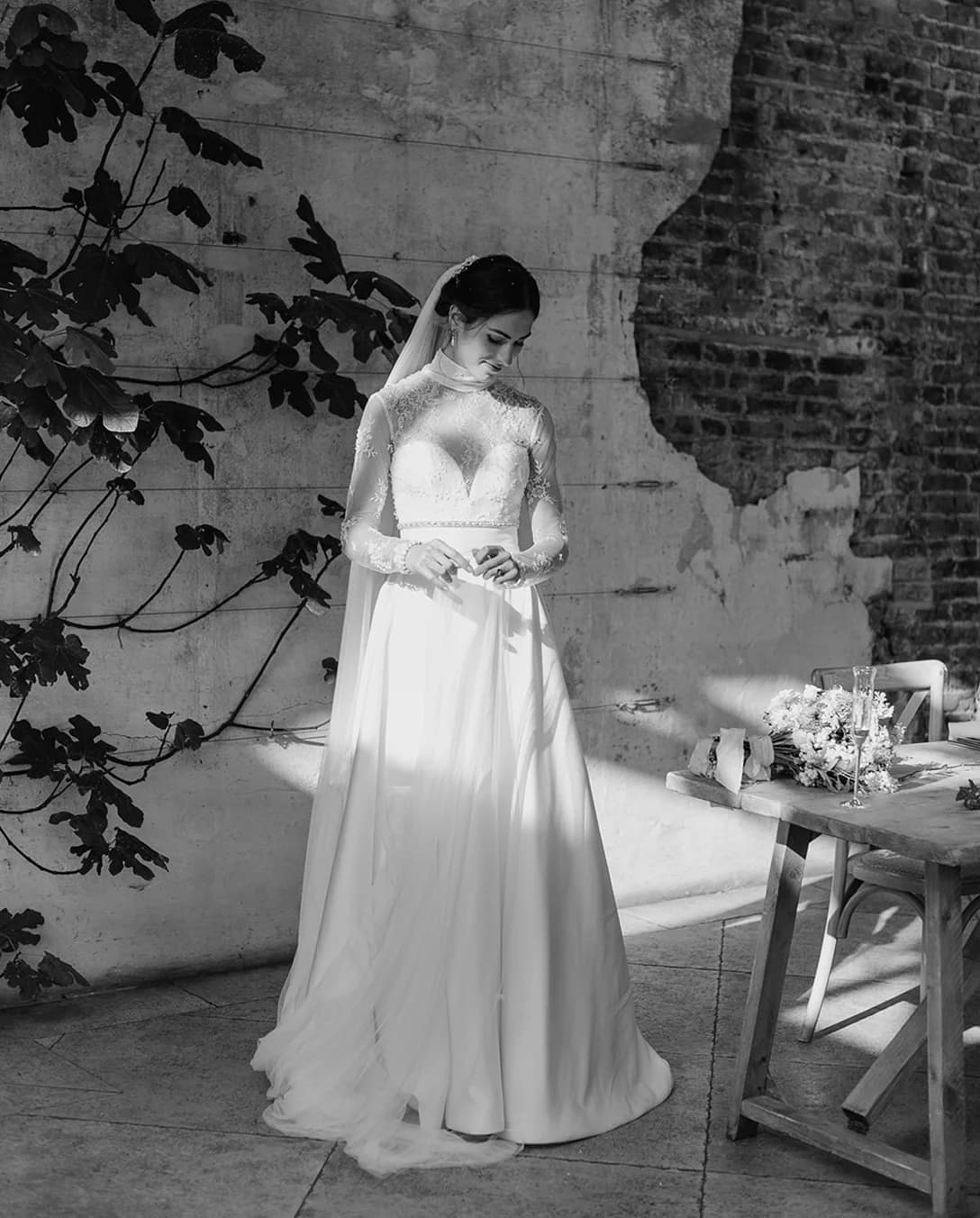Bride stands in the Middleton Lodge's Fig House next to a fig tree