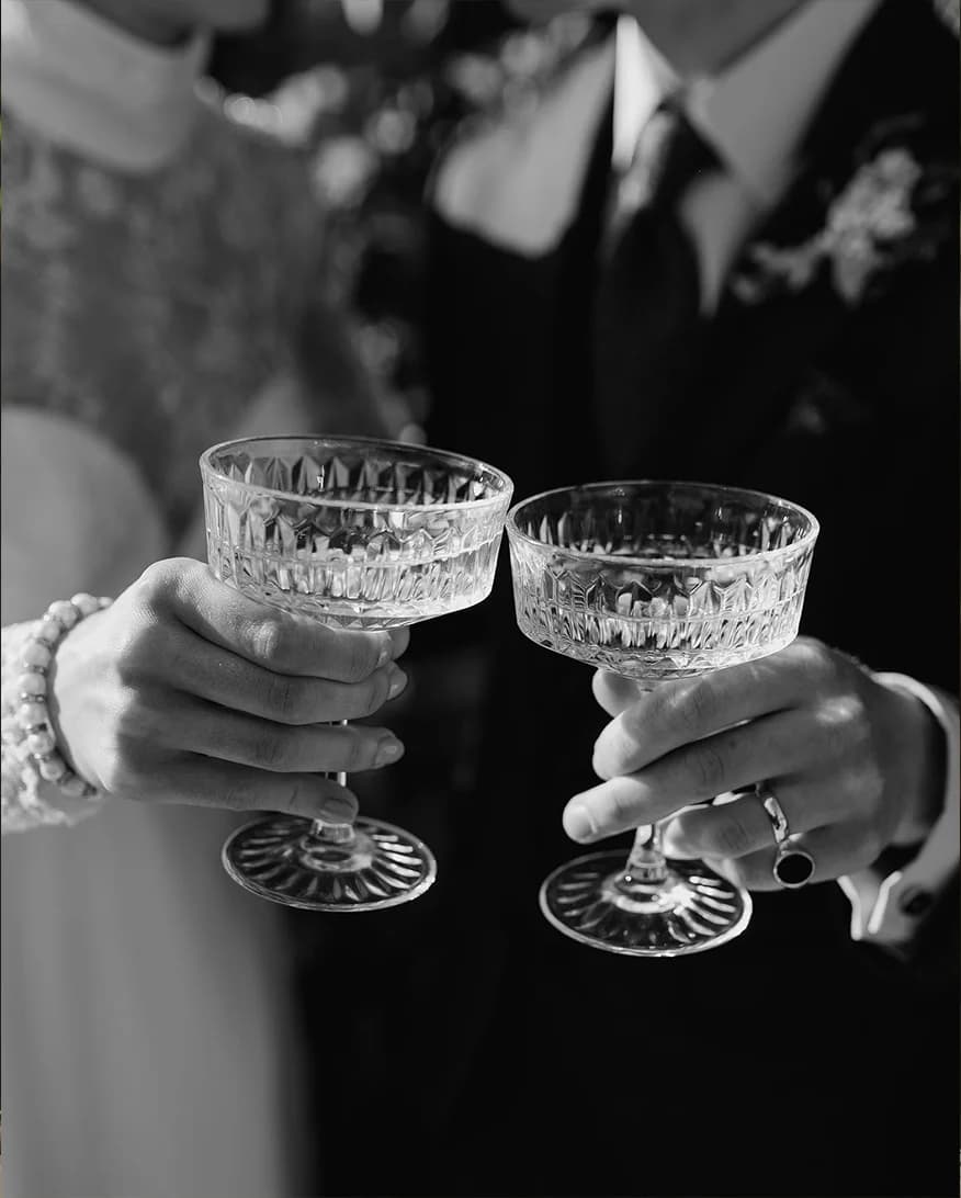 Bride and groom toasting with champagne coupes