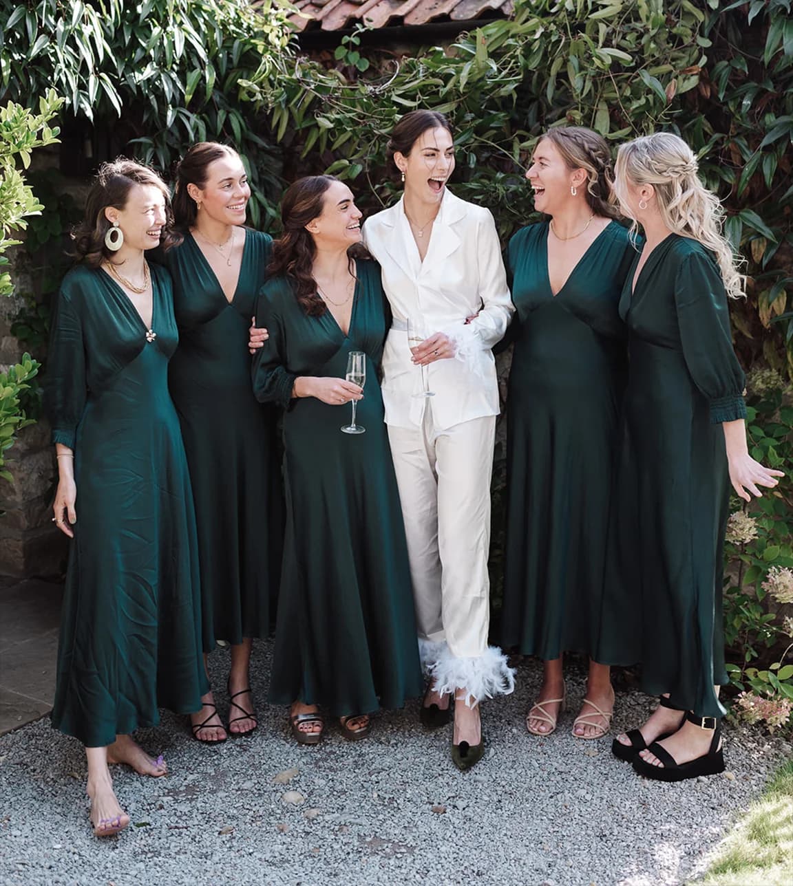 Bride enjoys her wedding morning with bridesmaids wearing matching dress