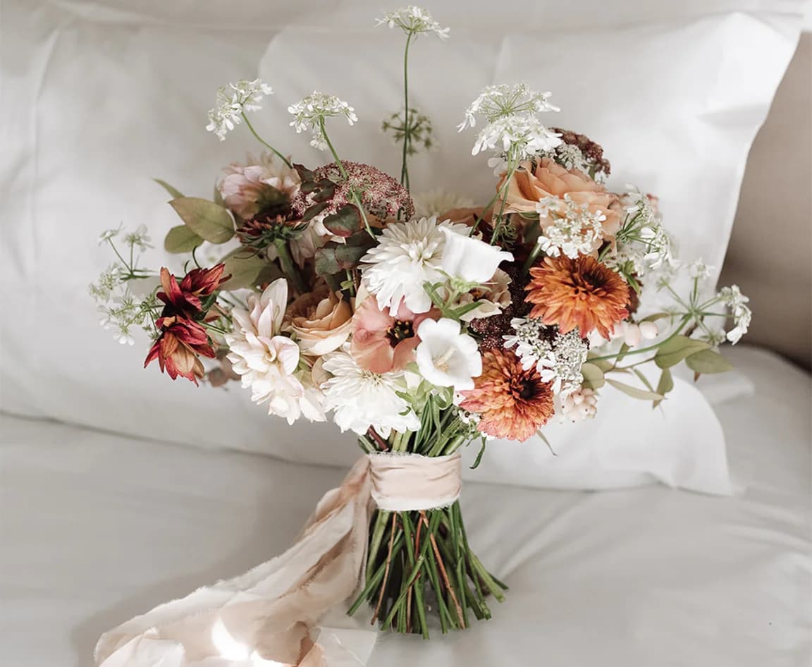Autumnal wedding bouquet for bride featuring dahlias, Canterbury bells, snowberries, blush roses, and delicate grasses