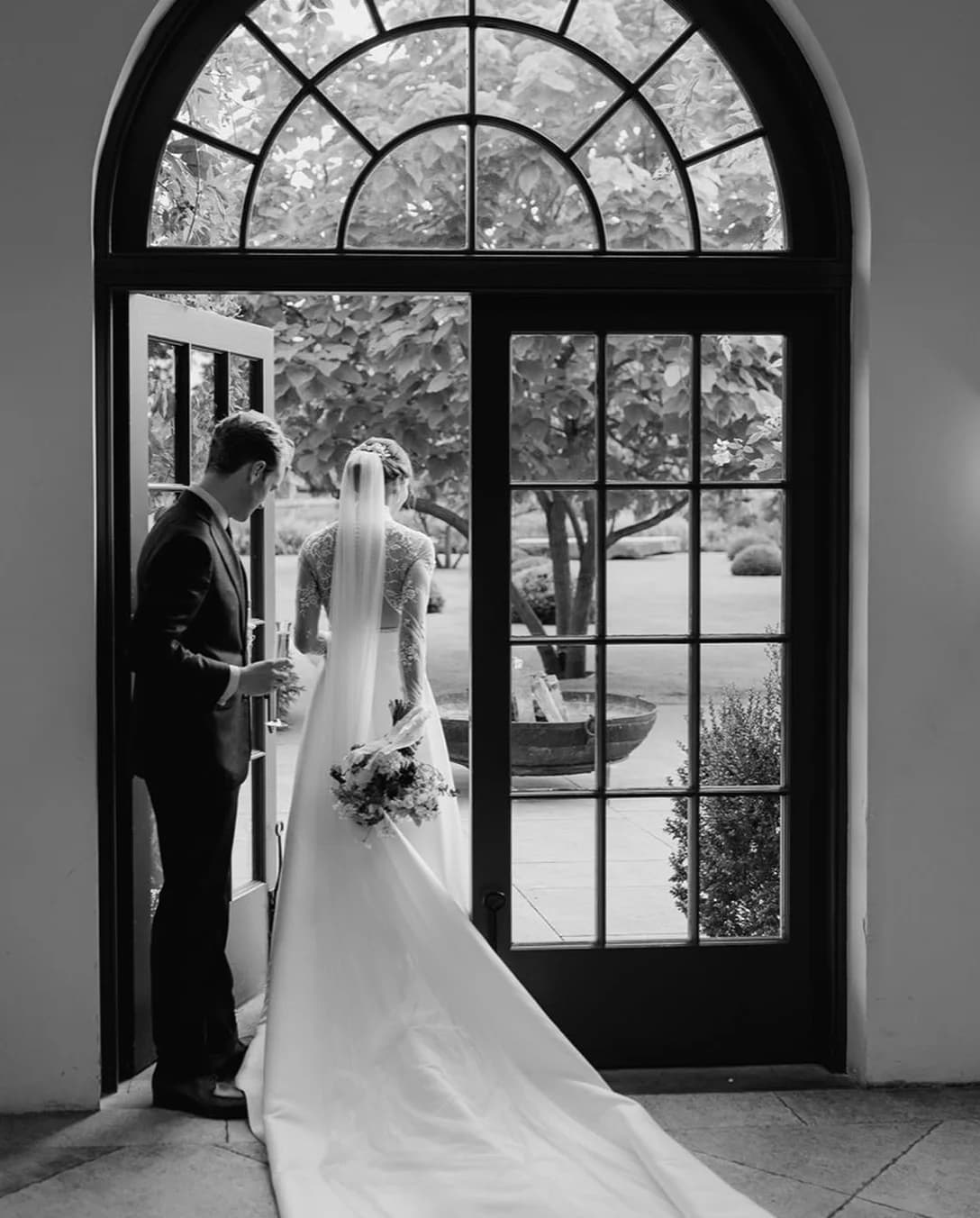 Bride groom open the door to the Middleton Lodge garden