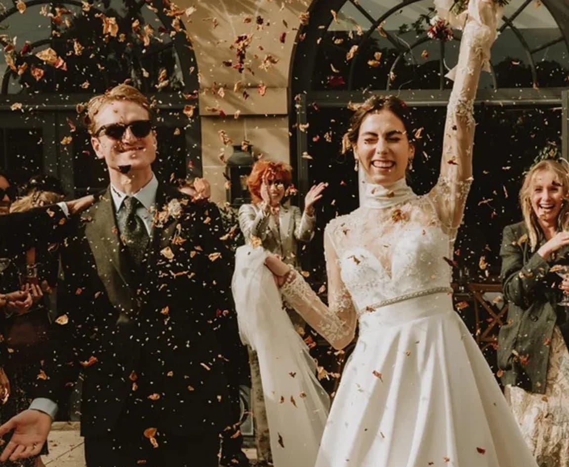 Bride and groom in the middle of confetti