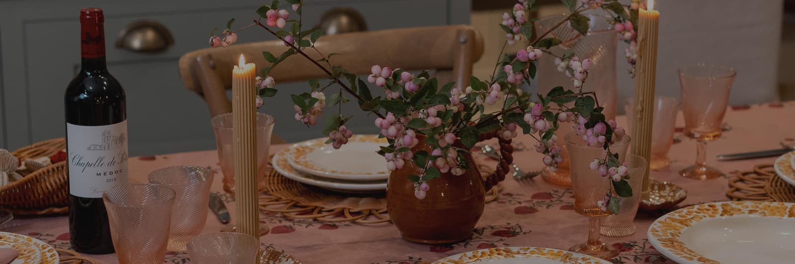 A tablescape with linen tablecloth and handpainted tableware