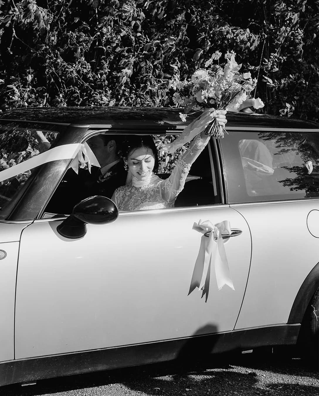 Bride and groom in their Mini Cooper wedding car