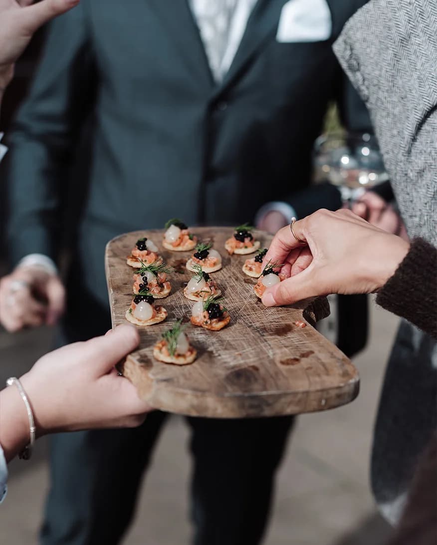 Wedding guests taking canapes from the tray