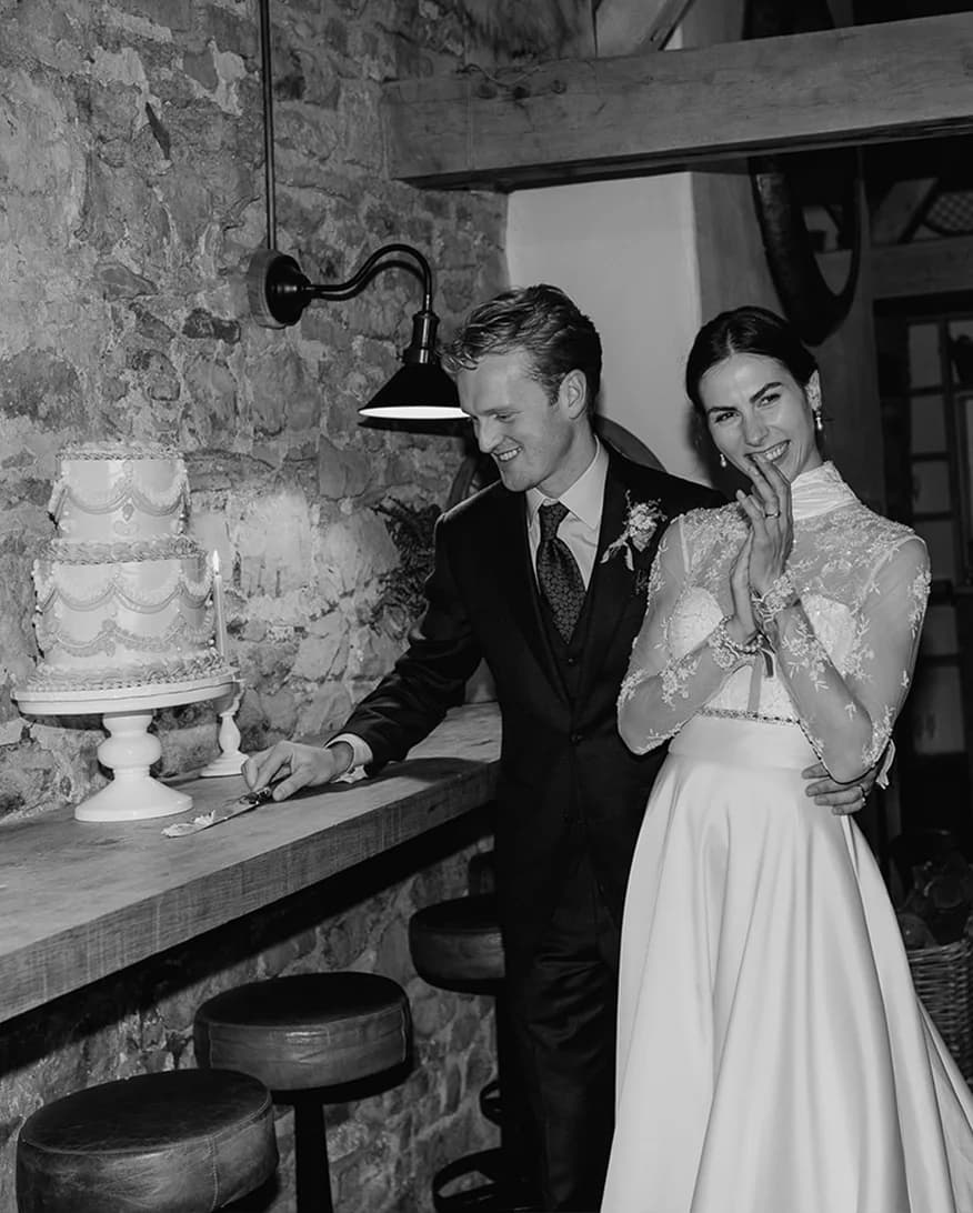 Bride and groom cutting their two tier Lambeth cake