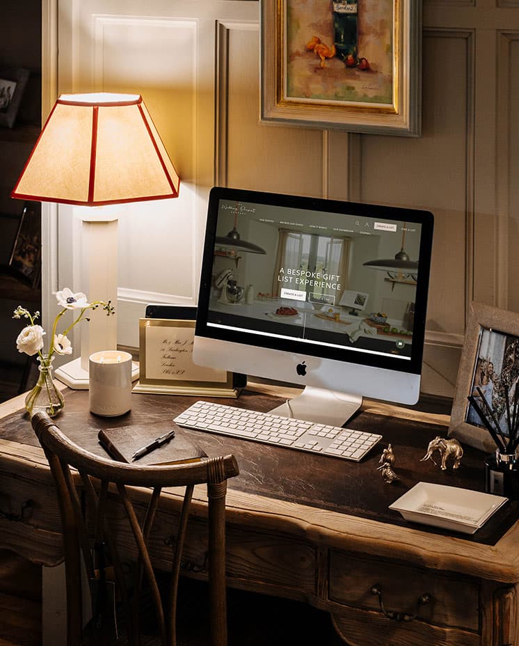 The Wedding List Advisor's computer screen displays The Wedding Present Company homepage.
