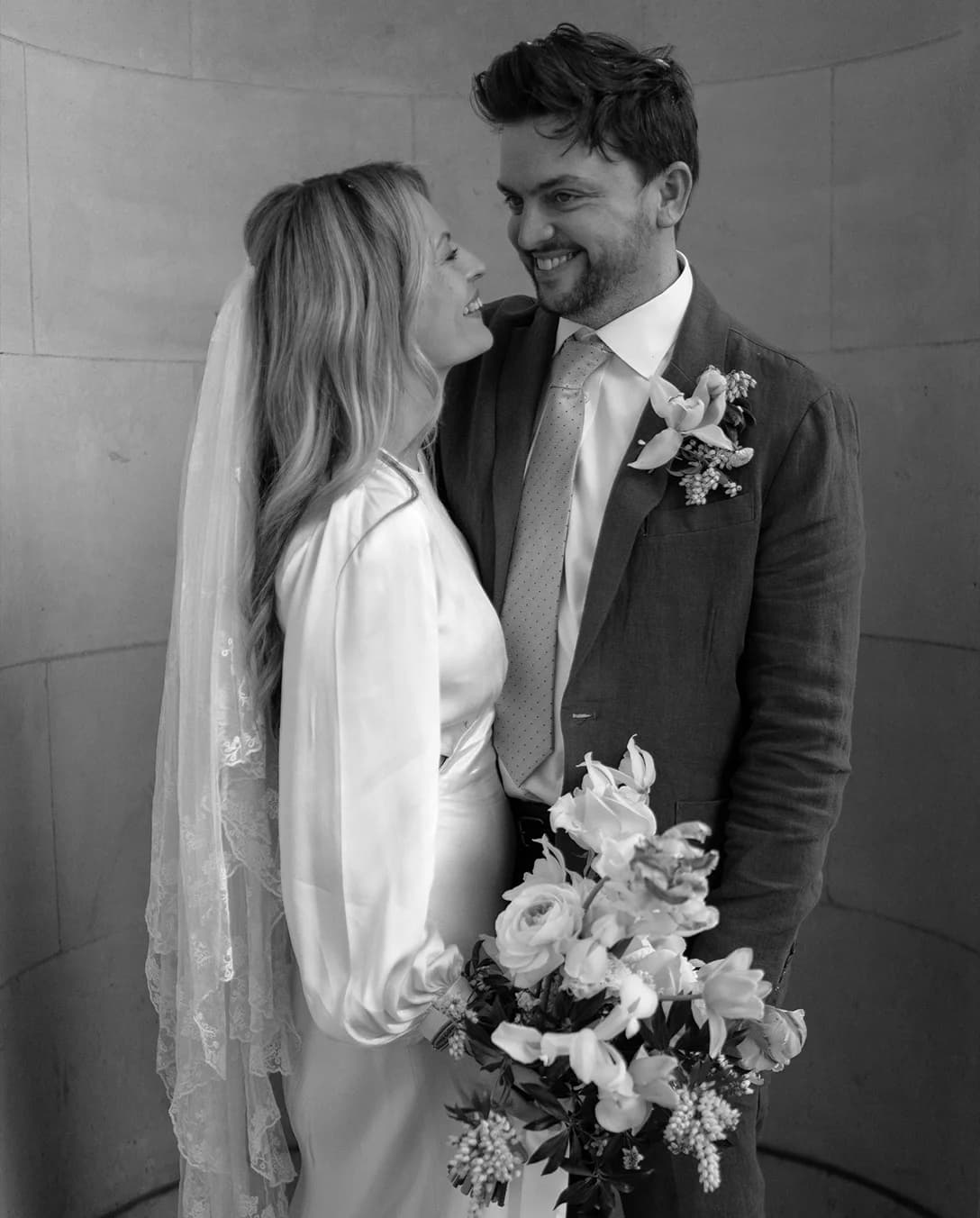 Bride and groom pose outside Marylebone Town Hall