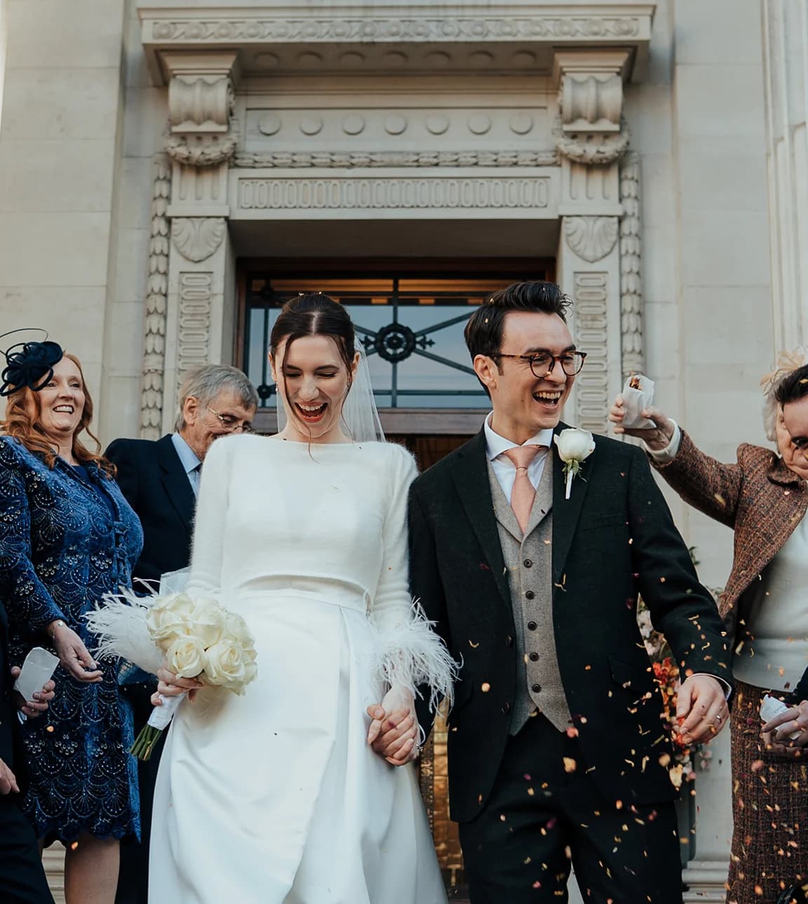 Bride and groom leave the Old Marylebone Town Hall after their winter wedding registry office wedding
