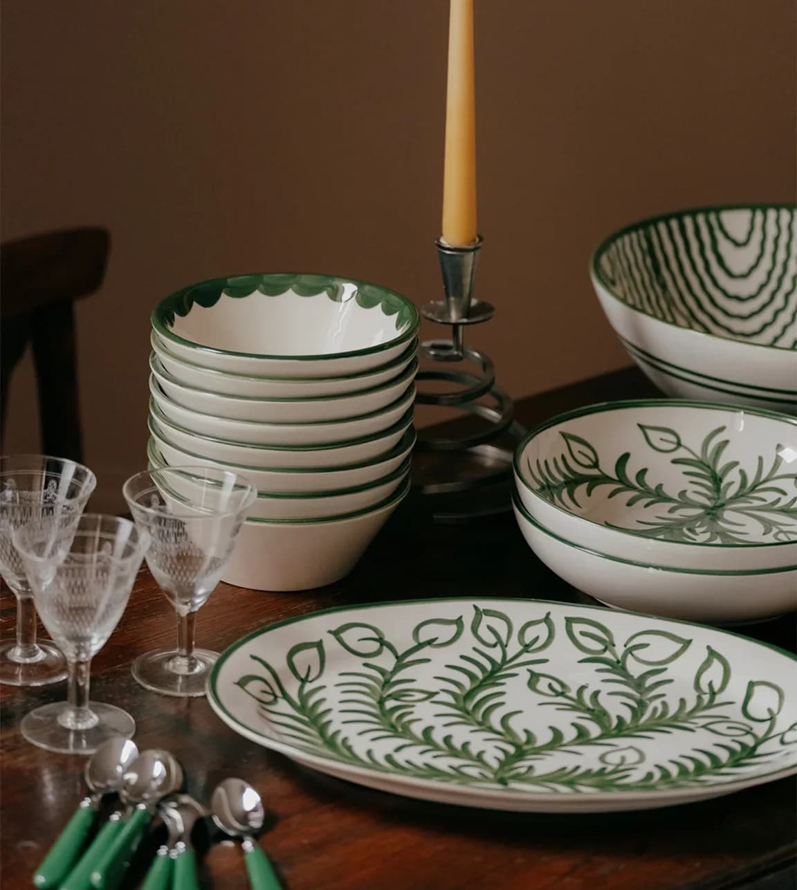 Green hand-painted Christmas tableware, including bowls, platters and plates