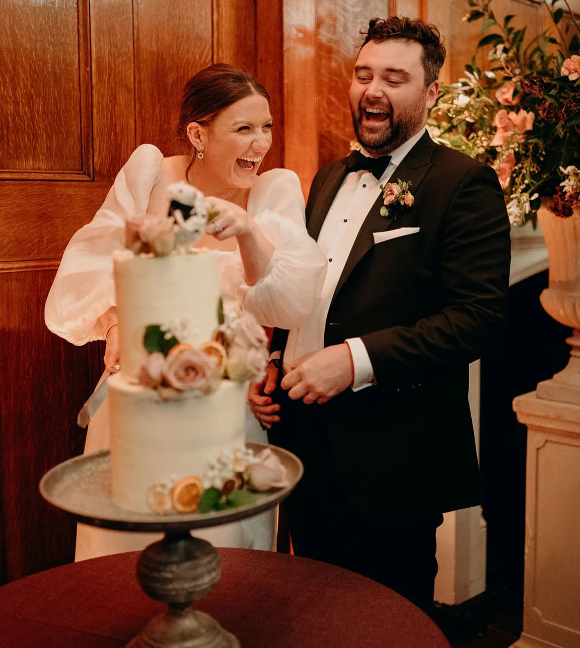 Bride and groom cut their 3 tiered wedding cake