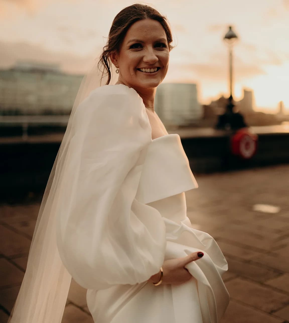 Bride wears Jesus Peiro bridal gown with gathered sleeves 