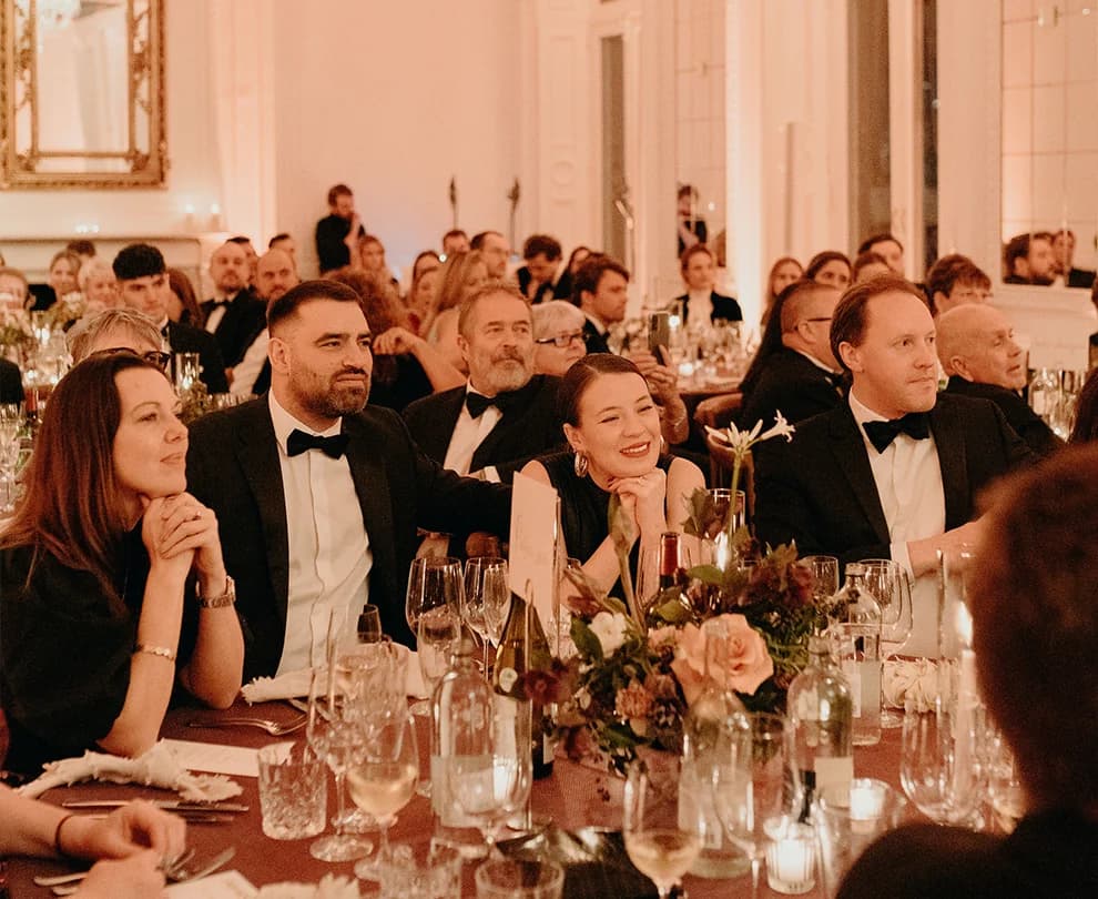 Wedding guests listen to speech during a wedding reception at The Belgravia