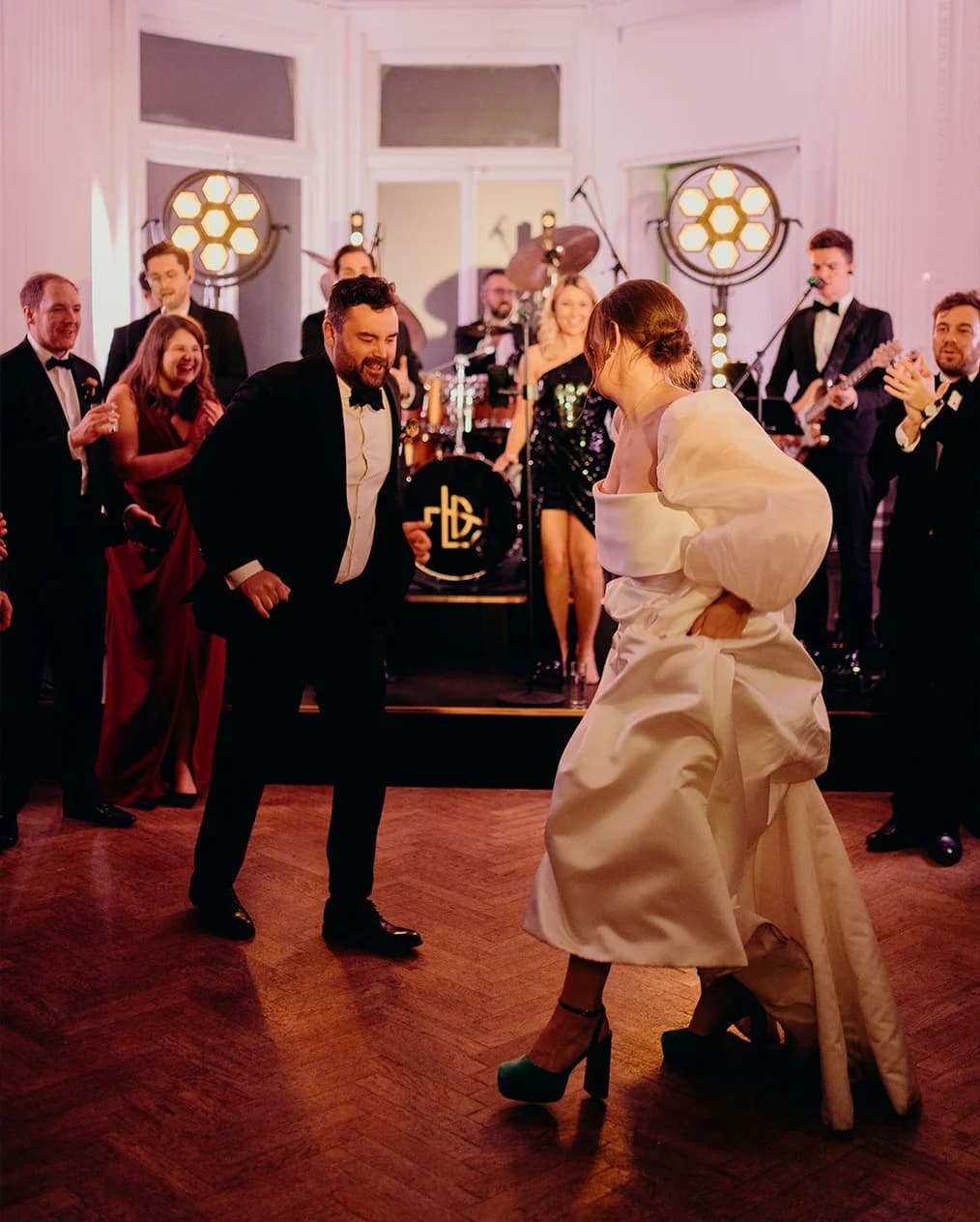 Bride and groom dance while LDN Showband plays in the background