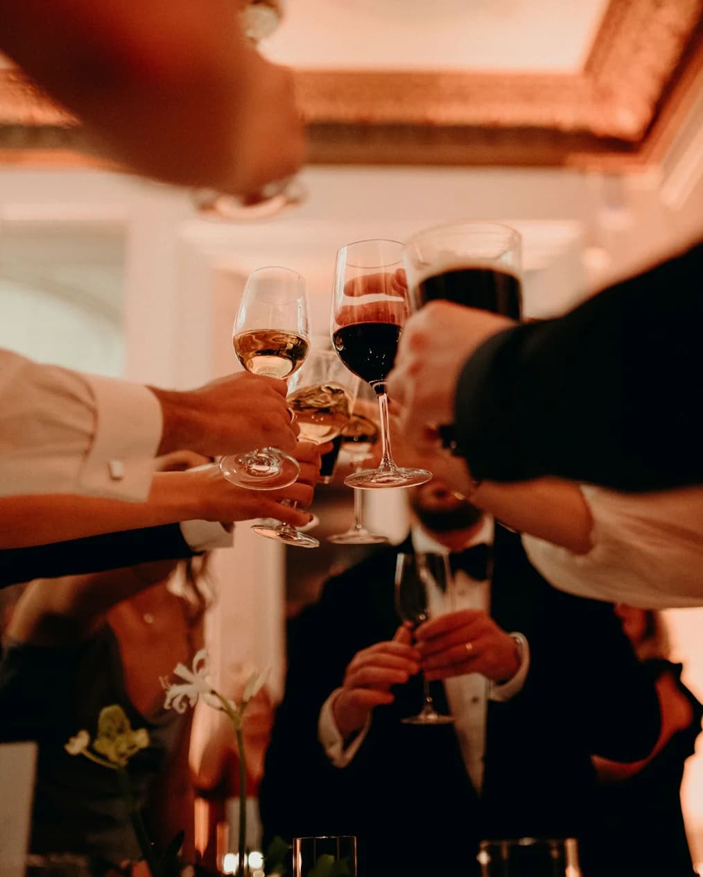 Wedding guests cheer with drinks and wine