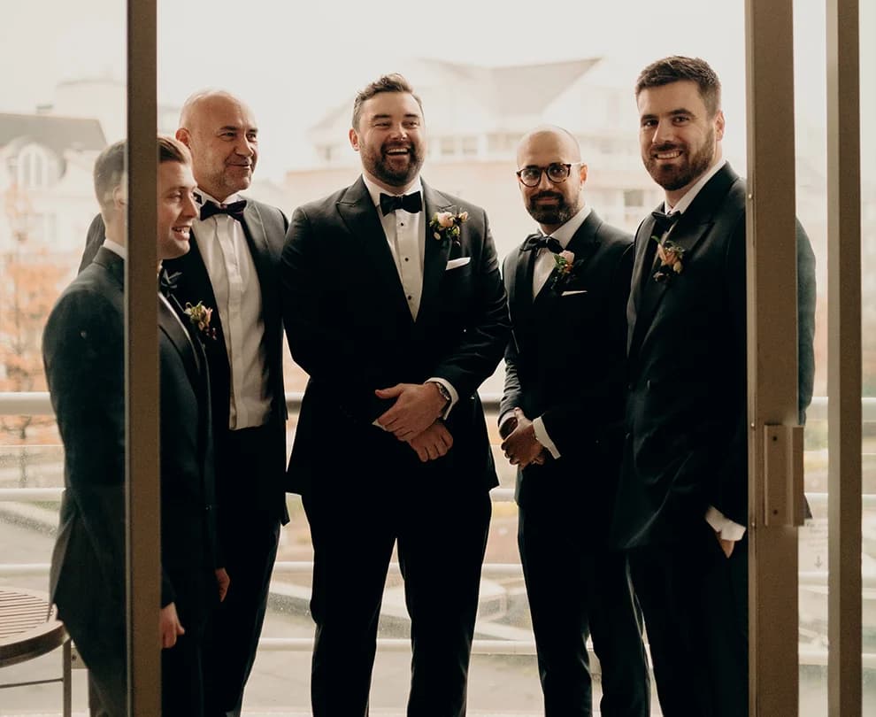 Groom standing on the balcony with groom's party