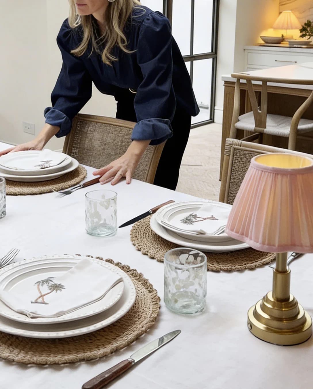 Pip adjusting the tableware and cutlery on the tablescape