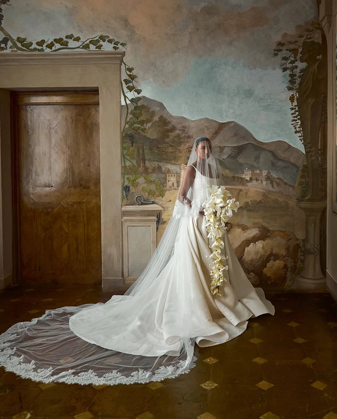 Noorie Ana poses inside Villa Centinale's room with hand-painted walls