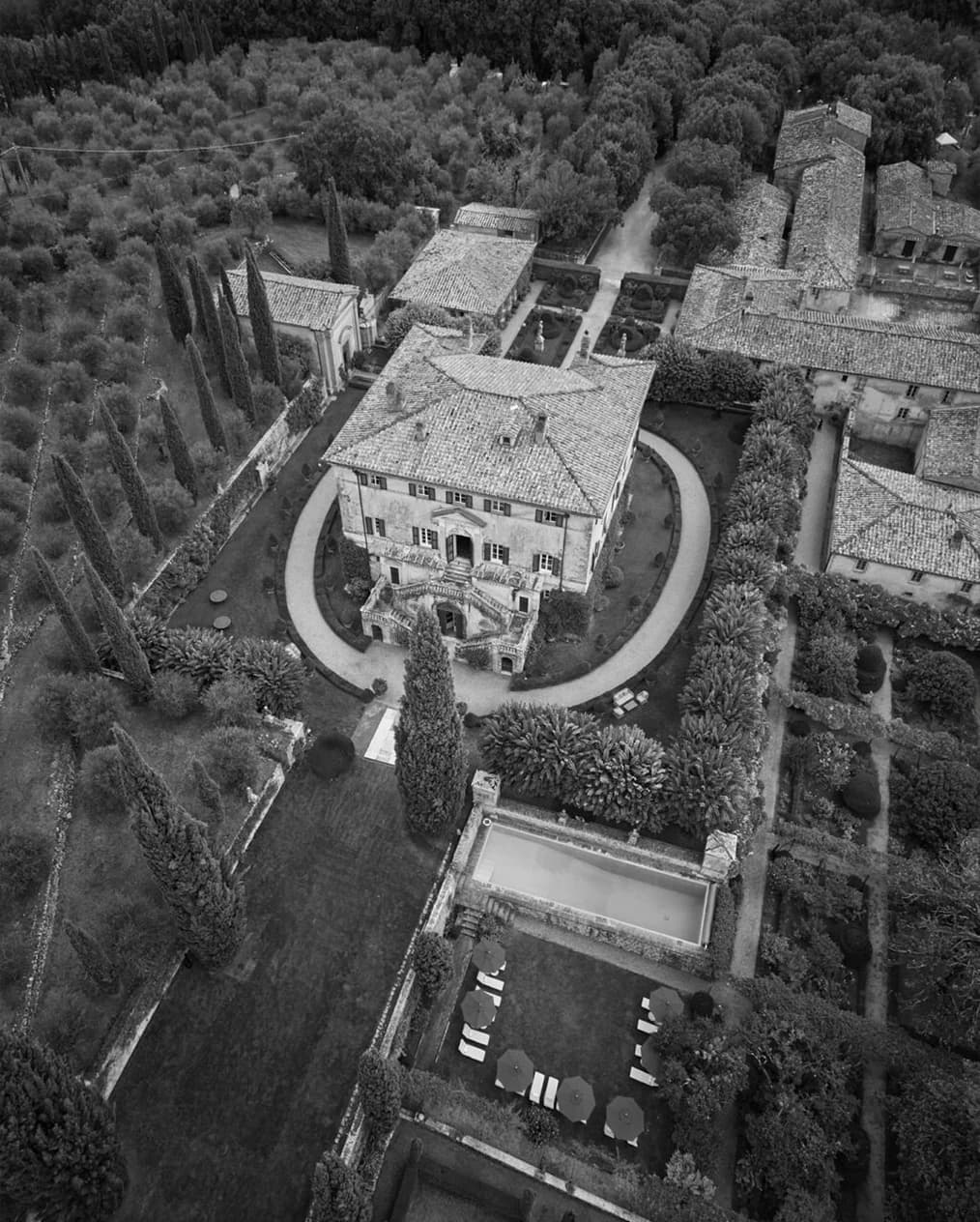 An aerial view of Villa Cetinale, showcasing the historic estate, formal gardens, and surrounding Tuscan landscape.