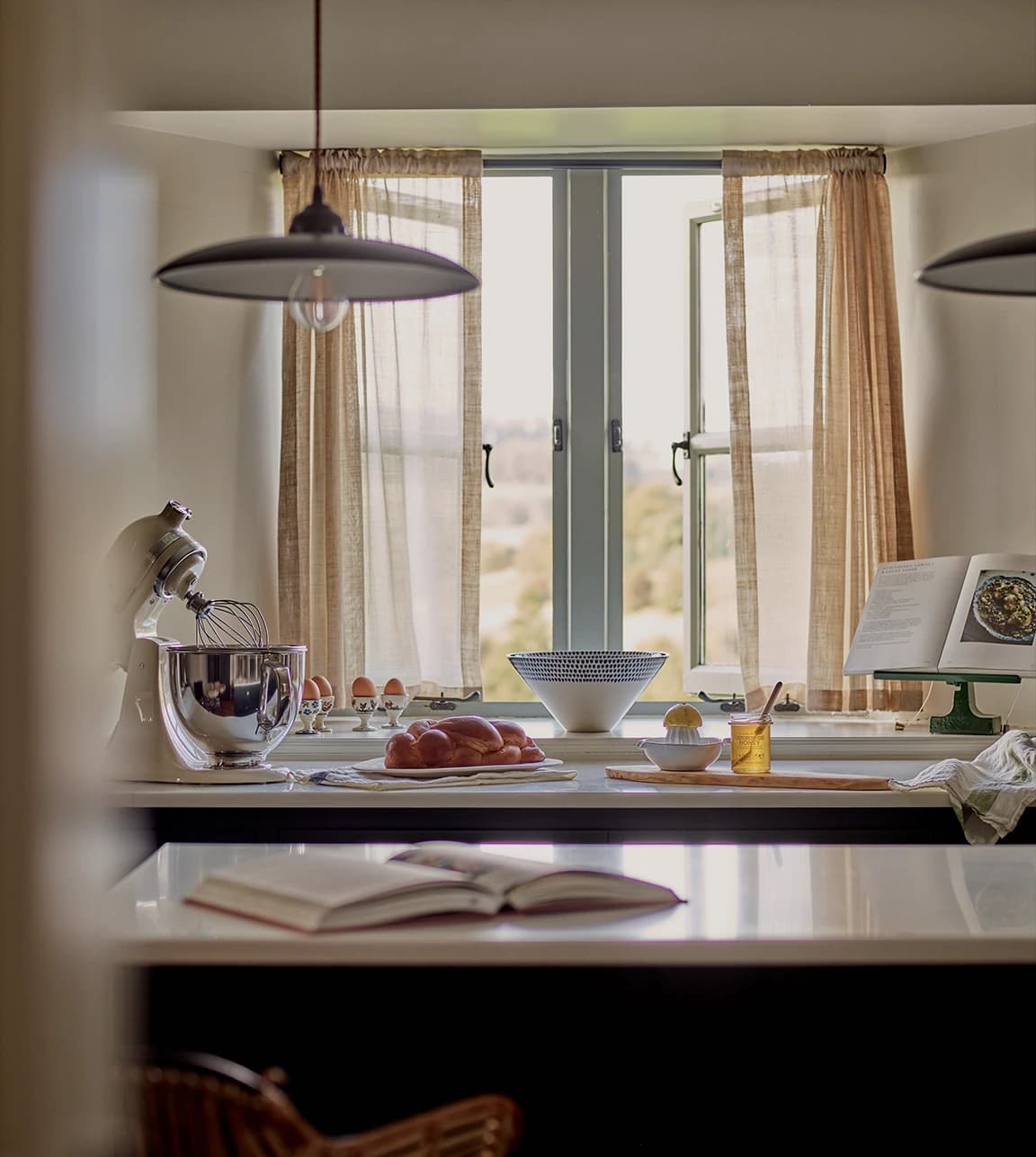 Bright kitchen with baking ingredients, utensils, and meaningful home gifts.