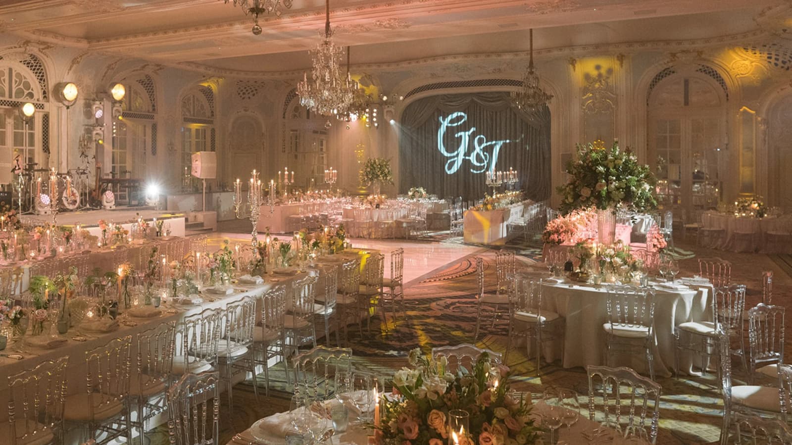Luxury wedding reception at The Savoy London with crystal chandeliers, candlelit tables, and elegant floral décor in a grand ballroom