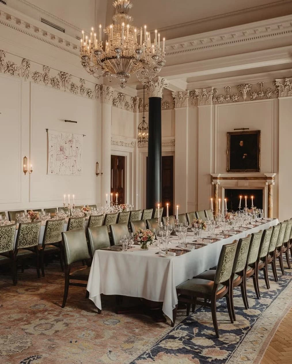 Elegant wedding reception dining room at The Ned London with long banquet tables, chandeliers, and candlelit décor