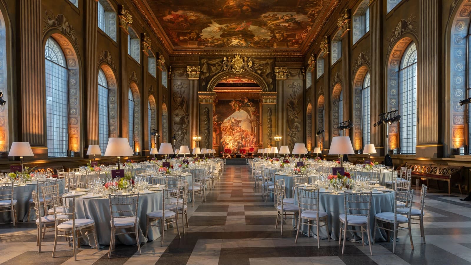 Wedding reception at Old Royal Naval College London with grand painted hall, long tables, and elegant historic setting