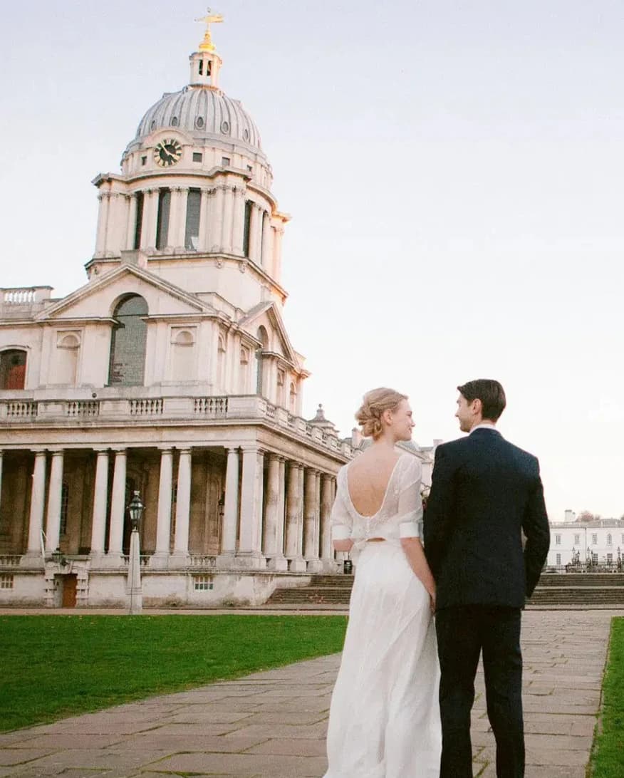 Bride and groom outside Old Royal Naval College London with historic architecture and iconic domed building