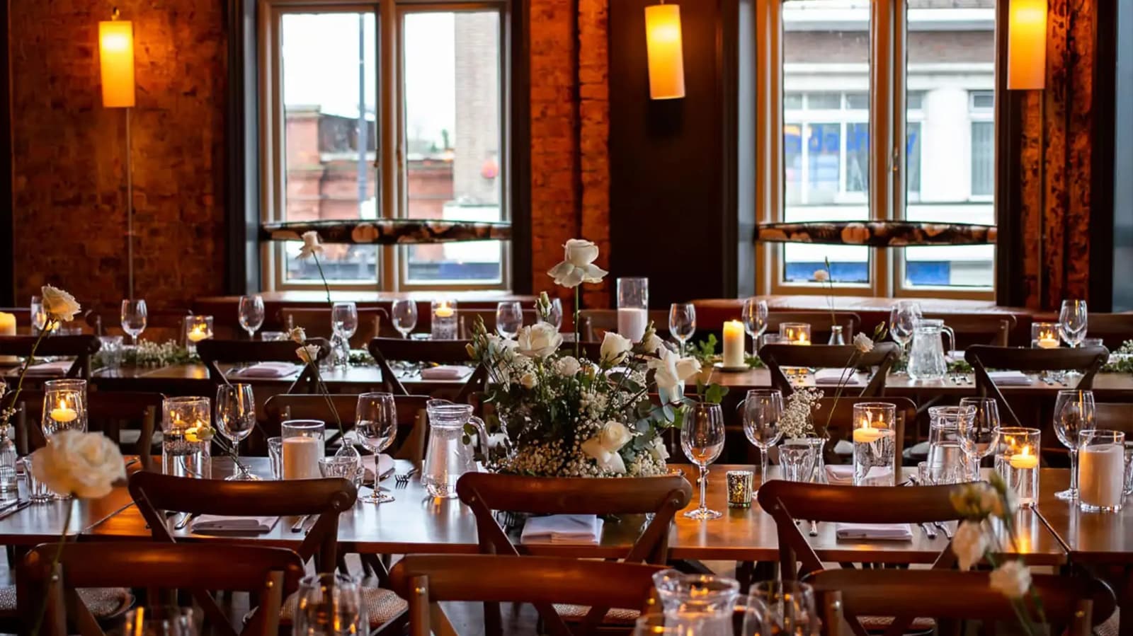 Wedding reception at The Railway Putney London with candlelit tables, floral centrepieces, and warm rustic interiors