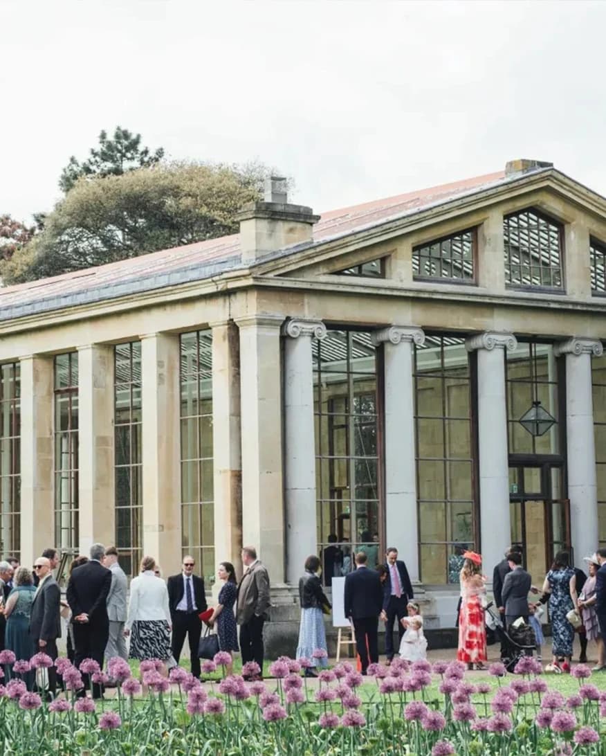 Guests outside Kew Gardens Nash Conservatory London with historic glasshouse architecture and garden setting