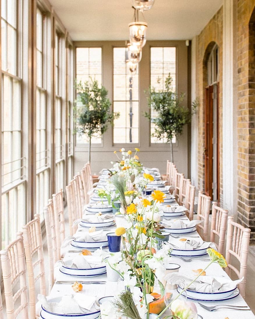 Wedding reception at Pitzhanger Gallery & Manor London conservatory with long table, floral décor, and natural light