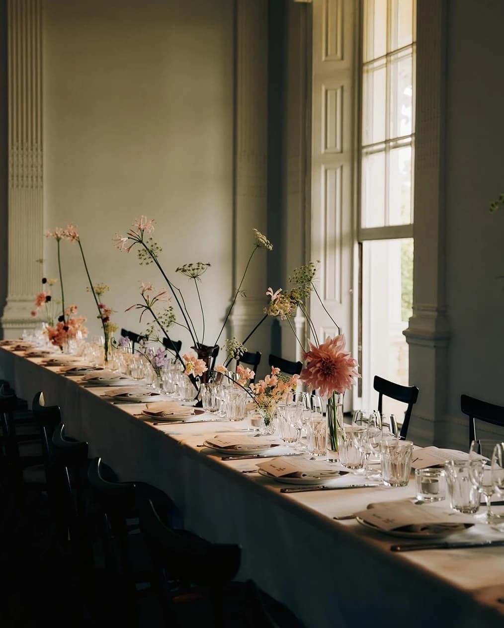 Elegant wedding reception at Bistroteque in Bethnal Green with delicate floral arrangements, long table setting, and natural light