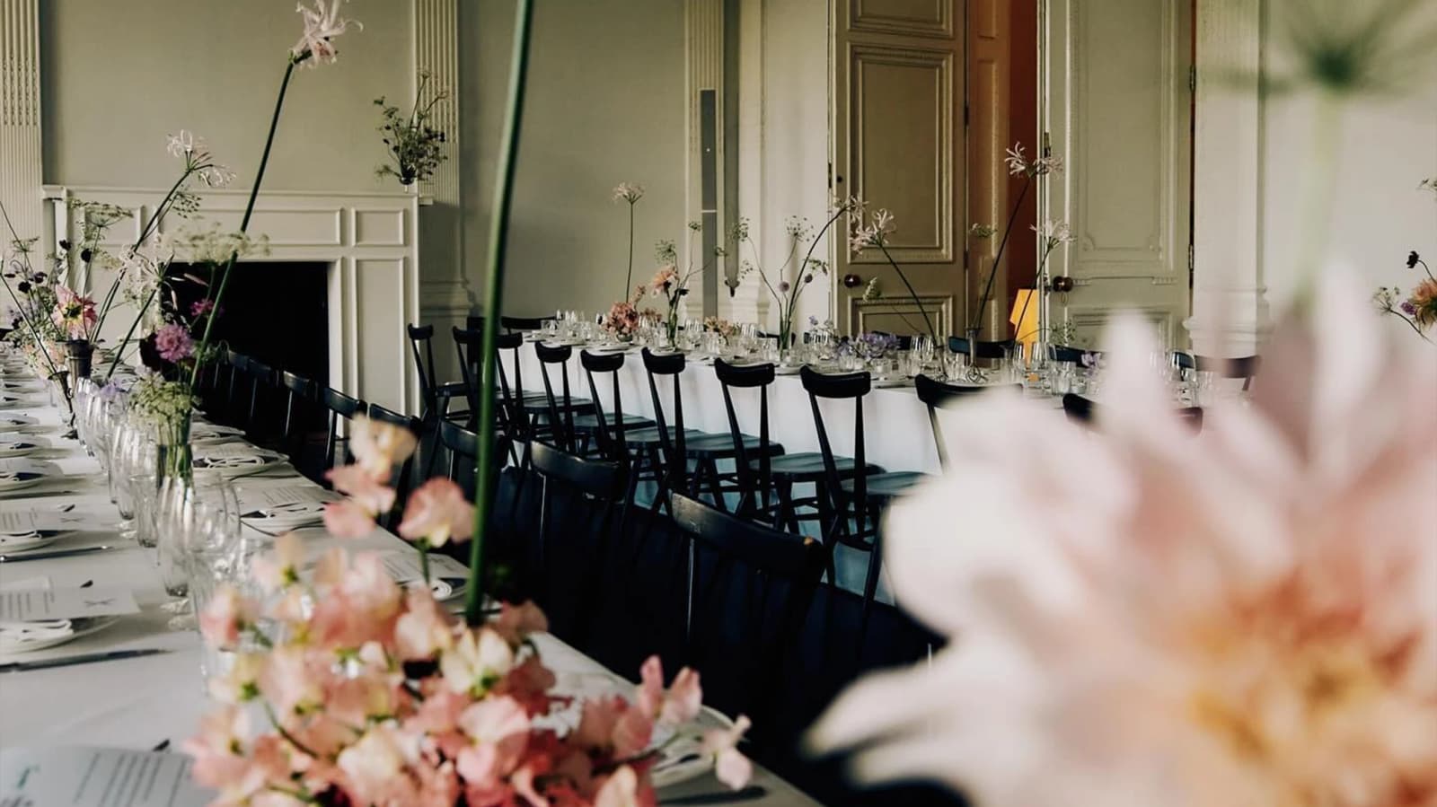 Wedding reception at Bistroteque London with long banquet tables, delicate floral arrangements, and elegant interiors