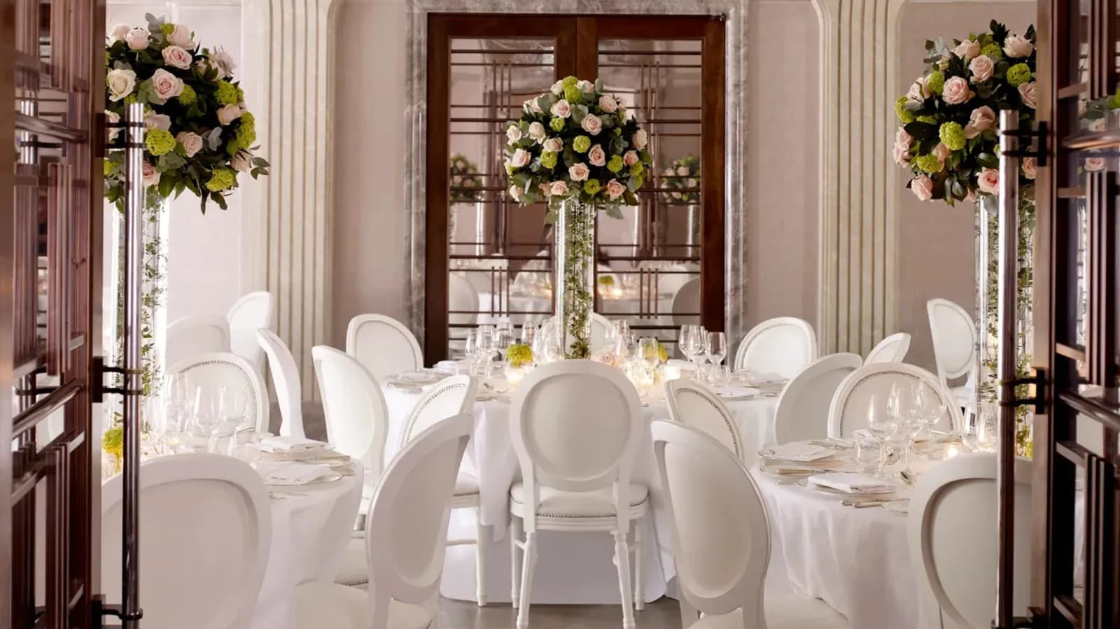 Luxury wedding reception at The Connaught London with elegant white décor, floral centrepieces, and refined interiors