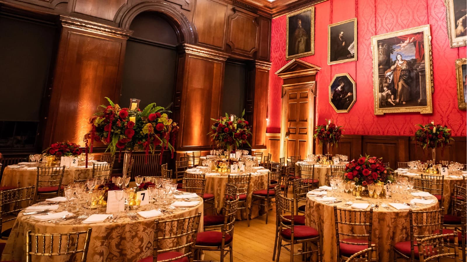Wedding reception at Kensington Palace King’s Drawing Room London with ornate interiors, red walls, and elegant table settings