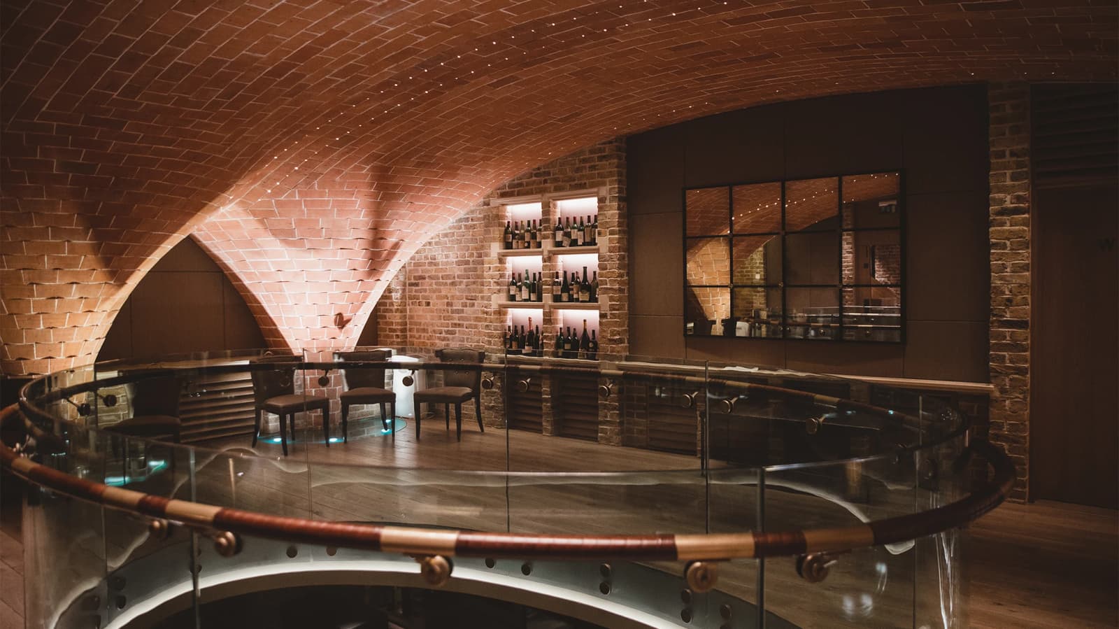 Wedding venue at Berry Bros. & Rudd London with vaulted brick ceiling, wine cellar setting, and intimate reception space