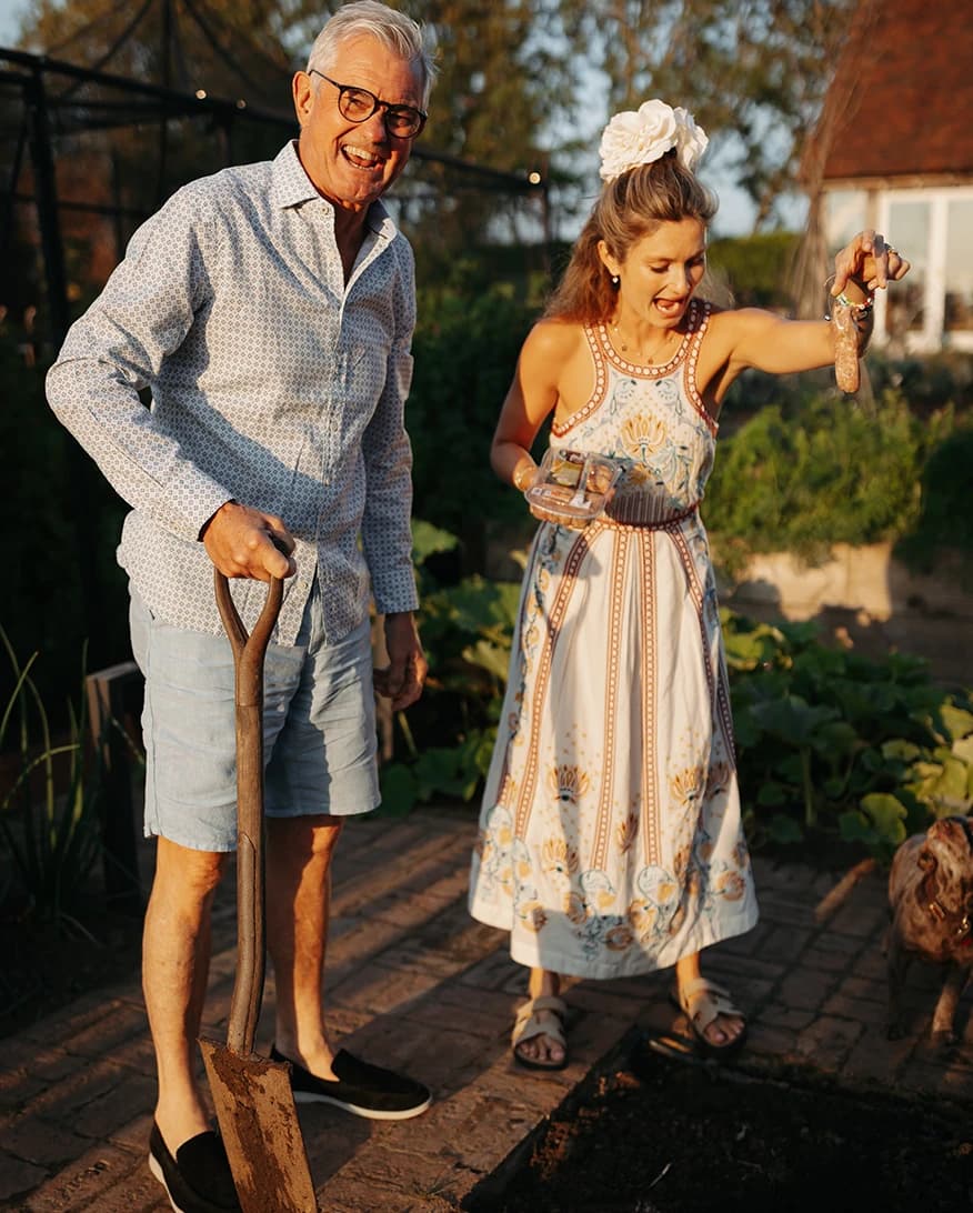 Honour and her father taking part in the tradition of burying a sausage for good weather before a luxury countryside wedding.