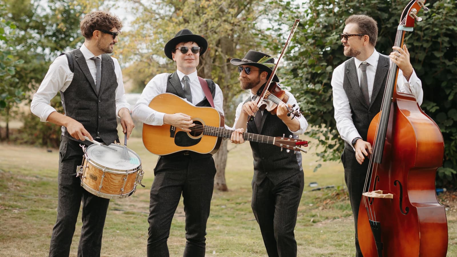 Wedding band The Roaming Brothers playing music on instruments