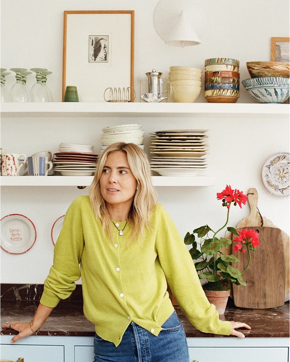 Lucy Williams at home, standing in front of her blue kitchen counters