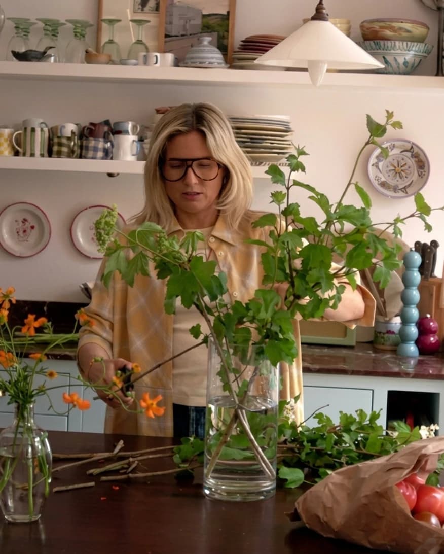 Lucy Williams at home, arranging flowers in her kitchen