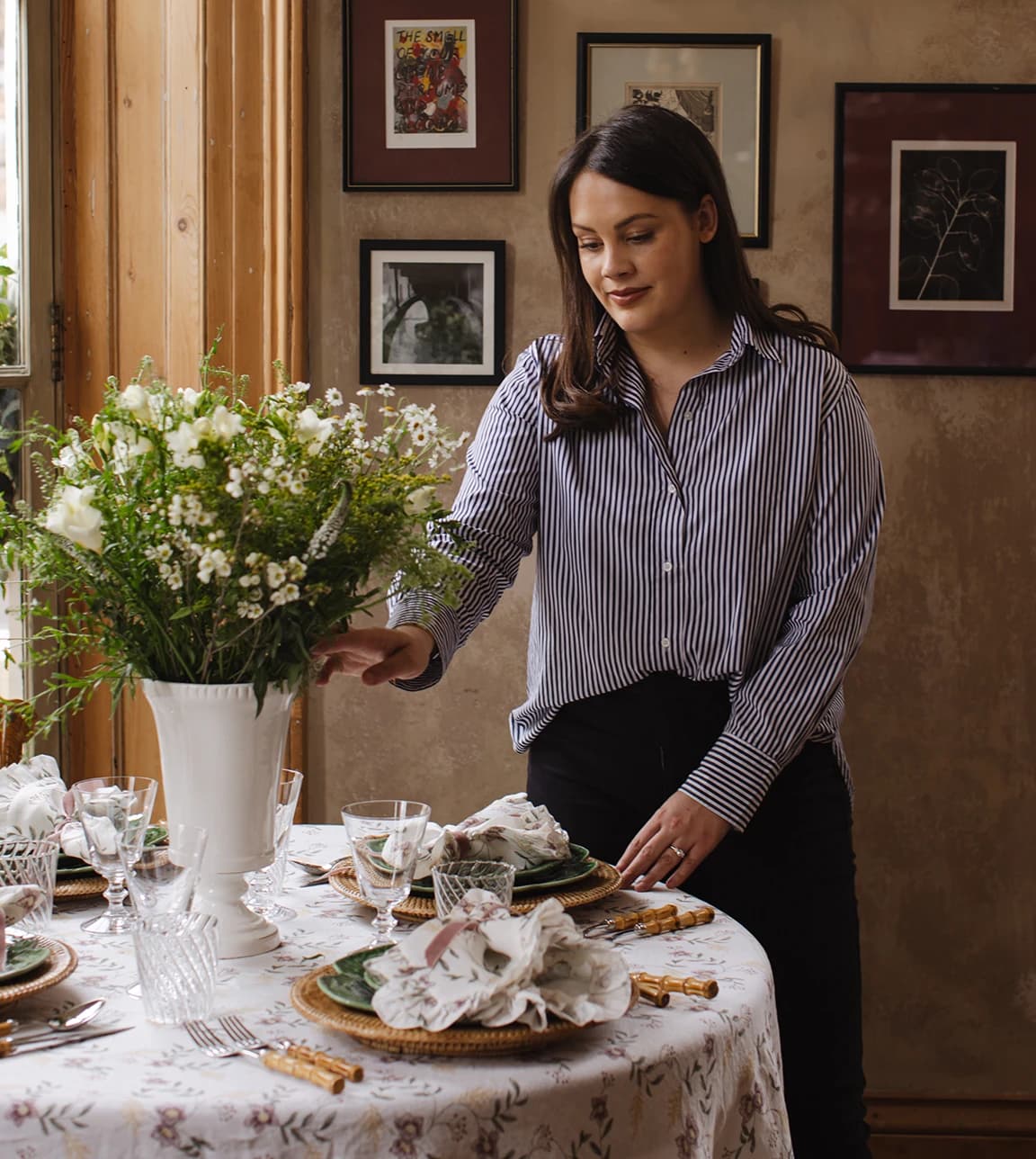 Rebecca Udall fixes the flowers on a beautifully set round table