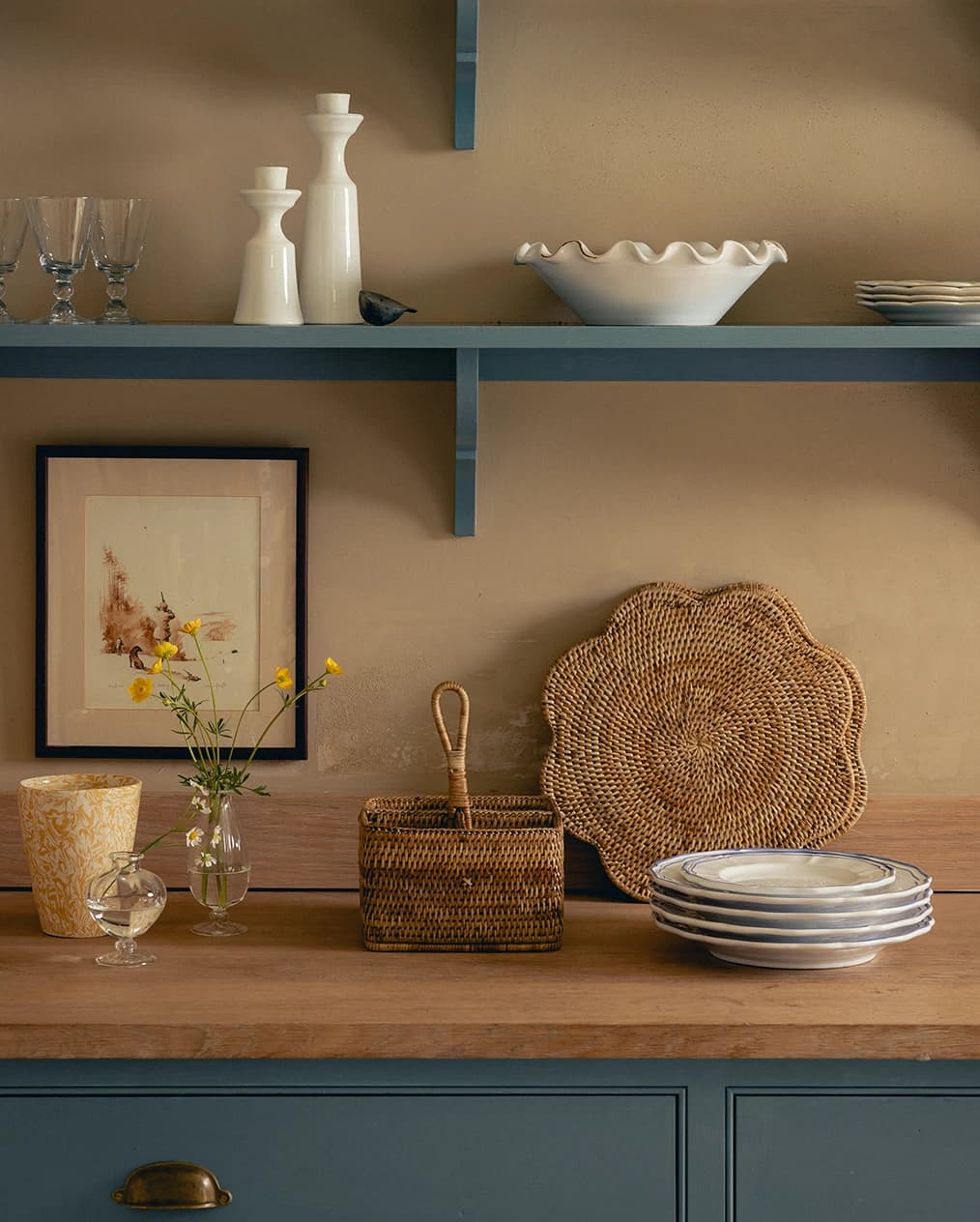 Rattan scalloped placeholder and condiment holder displayed on a blue kitchen counter