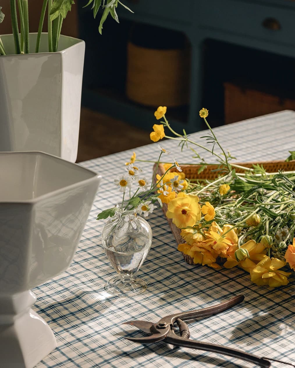 Simple flowers being arranged on a kitchen table