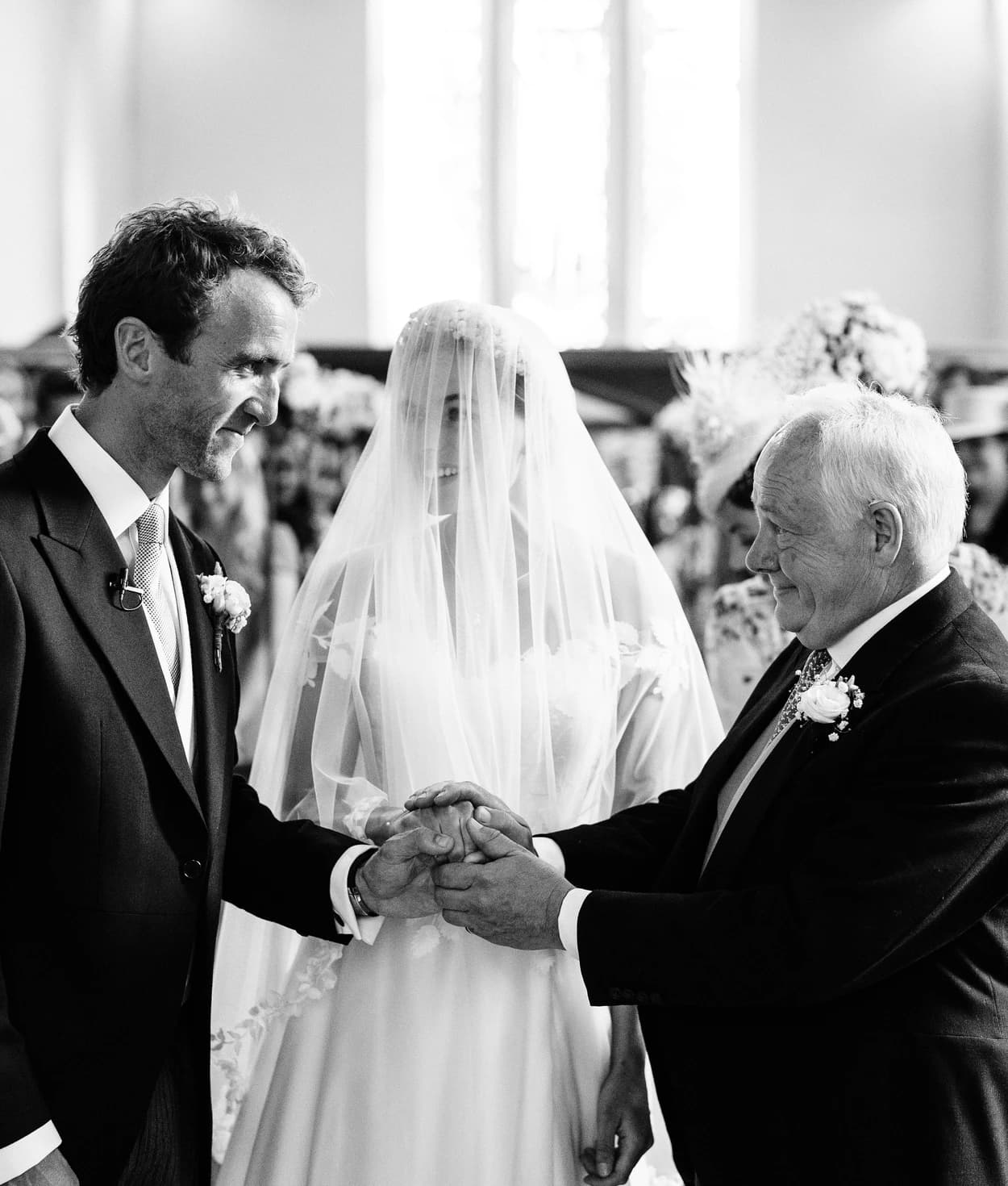 Father of bride gives away the bride to the groom