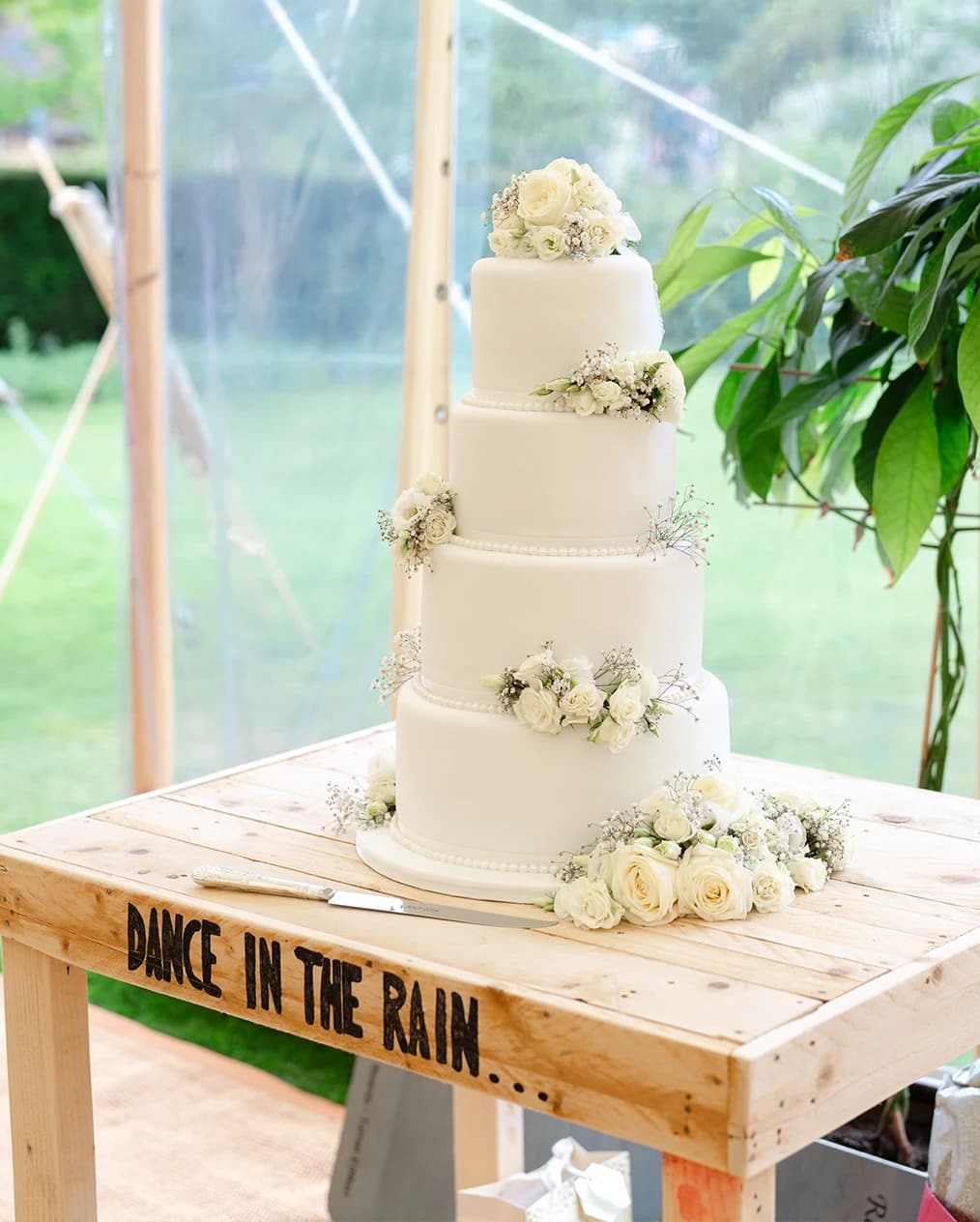A table with three tier wedding cake