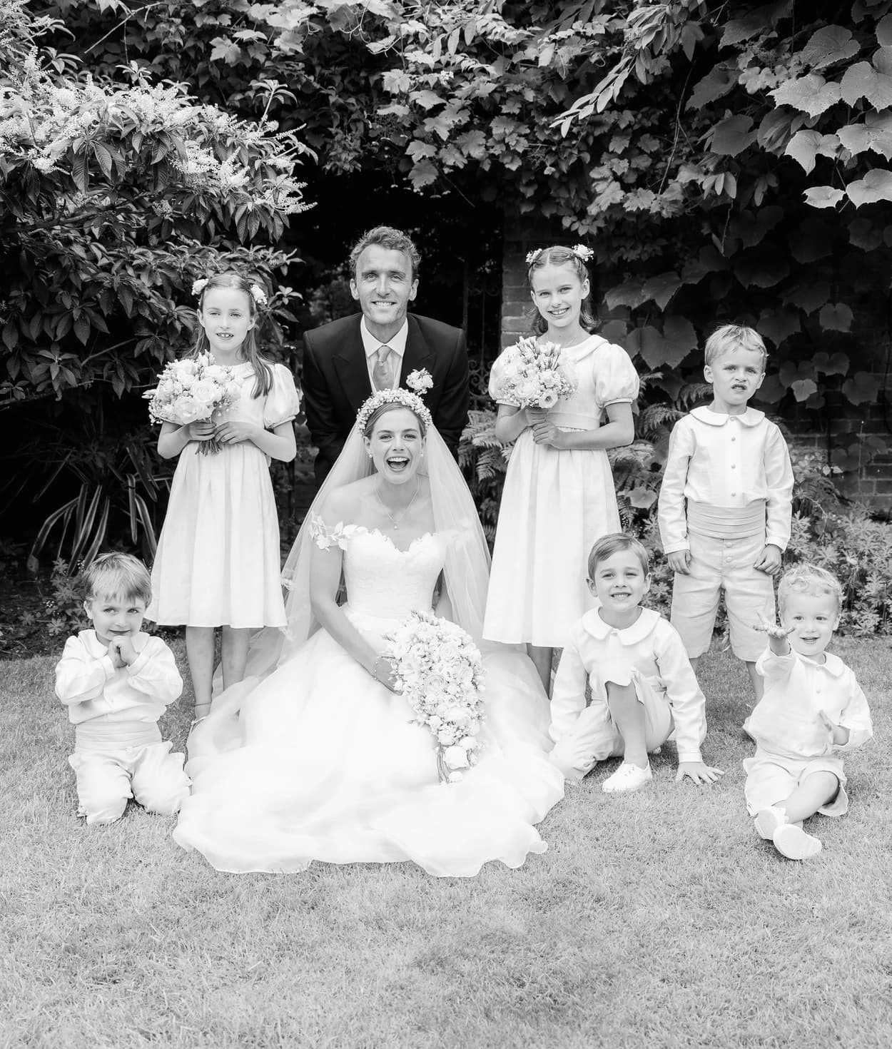 Bride, groom and their flowers girls and page boys